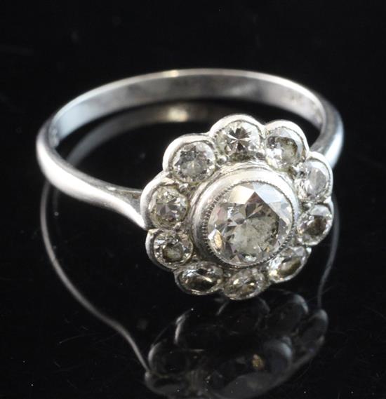 A 1920s platinum and diamond cluster ring, size K.